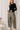 Model wearing black Boat Neck Semi Bell Long Sleeve Knit Top with beige patterned pants