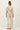 Back view of model wearing stone cotton modal fleece sweatshirt with matching pants