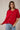 Model wearing red short sleeve sweater cardigan with jeans