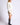 Side view of model wearing Chiara white long-sleeve pullover sweater