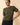 Model wearing cream ribbed knit top with brown pants