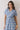 Embroidered Floral Tiered Button Down Midi Dress featuring a collared neckline and short sleeves, modeled by a young woman.