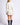 Back view of model wearing Chiara white long-sleeve pullover sweater