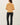 Back view of model wearing yellow button-up cardigan with black pants