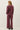 Back view of model wearing burgundy sweater with matching pants