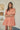Model wearing the Dixie Split Neck Shift Dress Drift Floral in Org Pinks Multi, showing breathable fabric and split neckline.