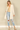 Shop Wall long sleeve open front cardigan in cream with side pockets worn by a model with distressed jeans