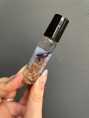 Peach Moonstone Crystal Perfume Roller in a glass bottle with gemstones and flowers, 10 ml size.