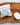 Shower Steamers -Wrapped Singles Rosemary & Spearmint scent, displayed on a wooden surface with dried herbs.