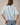 Back view of model wearing light blue short sleeve sweater cardigan