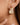 18K Gold Plated Waterproof Stainless Steel Hoop Earrings 7101 close-up of the earring on a model