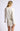 Back view of model wearing white Chiara long-sleeve pullover sweater