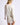 Back view of model wearing white Chiara long-sleeve pullover sweater