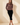 Full-length view of model wearing brown striped knit long sleeve button up cardigan with black pants