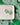 Shamrock Heart Earrings Clover Heart Earrings displayed on a plate with a green clover patterned background.