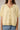 Close-up of model wearing yellow short sleeve sweater cardigan