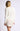 Full-length view of model wearing white Chiara long-sleeve pullover sweater