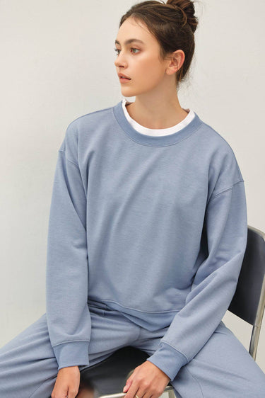 Model wearing light blue Cloud sweatfleece cropped shirt
