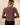 Back view of model wearing brown striped knit long sleeve button up cardigan with black pants