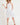 Floral Print Pleated Fit & Flare With Embroidery dress on model wearing a straw hat and sandals.
