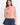 Pearl Button Ribbed Knit Cardigan in pink styled on a model with denim shorts