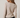Back view of model wearing white Boat Neck Semi Bell Long Sleeve Knit Top with black pants