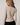 Back view of model wearing white Boat Neck Semi Bell Long Sleeve Knit Top with black pants