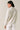 Back view of model wearing beige melange Half Zip Funnel Neck Long Sleeve Pullover Top