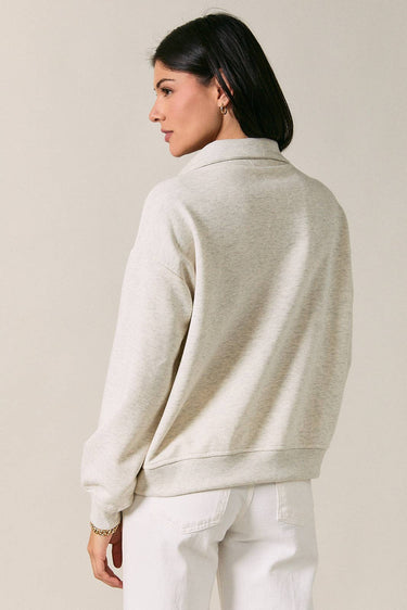 Back view of model wearing beige melange Half Zip Funnel Neck Long Sleeve Pullover Top