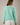 Back view of model wearing mint green Round Rolled Hemline Detail Thin Sweater Cardigan