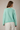 Back view of model wearing mint green Round Rolled Hemline Detail Thin Sweater Cardigan