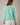 Back view of model wearing mint green Round Rolled Hemline Detail Thin Sweater Cardigan