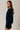Side view of model wearing navy blue Round Rolled Hemline Detail Thin Sweater Cardigan