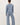 Back view of model wearing blue long sleeve top with matching pants