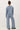 Back view of model wearing blue long sleeve top with matching pants