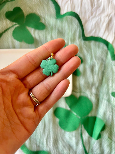 Four Leaf Clover Earrings Shamrock Earrings in a hand, highlighting the lightweight design and vibrant color.