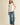 Model wearing Pleated throughout Sleeveless A Line Top with textured finish and pleated hem, paired with wide-leg jeans.