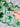 Shamrock Clay Studs Shamrock Stud Earrings displayed on a card, held against a green shamrock-patterned scarf.