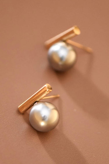 18K Gold Plated Waterproof Stainless Steel Stud Earrings 7743 displayed on a hand against a neutral background