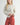 Irisha Diamond Pointelle Sweater in Oatmeal, featuring a diamond pattern and cozy fit, perfect for stylish layering.