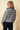 Round neck long-sleeve stripe sweater worn from the back, featuring a striped pattern and comfortable knit design.