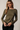 Front view of model wearing olive green Boat Neck Semi Bell Long Sleeve Knit Top with black pants