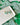 Shamrock Heart Earrings Clover Heart Earrings on a white plate against a green patterned background.