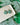 Two Tone Shamrock Earrings Clover Clay Earrings displayed on a plate with a green shamrock background.