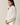 Side view of model wearing beige melange Half Zip Funnel Neck Long Sleeve Pullover Top