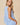 V-neck Baby doll Sleeveless Blouse with Ruffle Top in light blue, showing back view with gathered waist and ruffle detail.