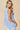 V-neck Baby doll Sleeveless Blouse with Ruffle Top in light blue, showing back view with gathered waist and ruffle detail.