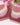 Red Feathers Organic Artisan Soap bars with floral background, showcasing natural colors and artisan design.