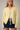 Front view of model wearing yellow Round Rolled Hemline Detail Thin Sweater Cardigan with navy shorts