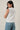 crew neck sleeveless diagonal panel stripe top side view on model